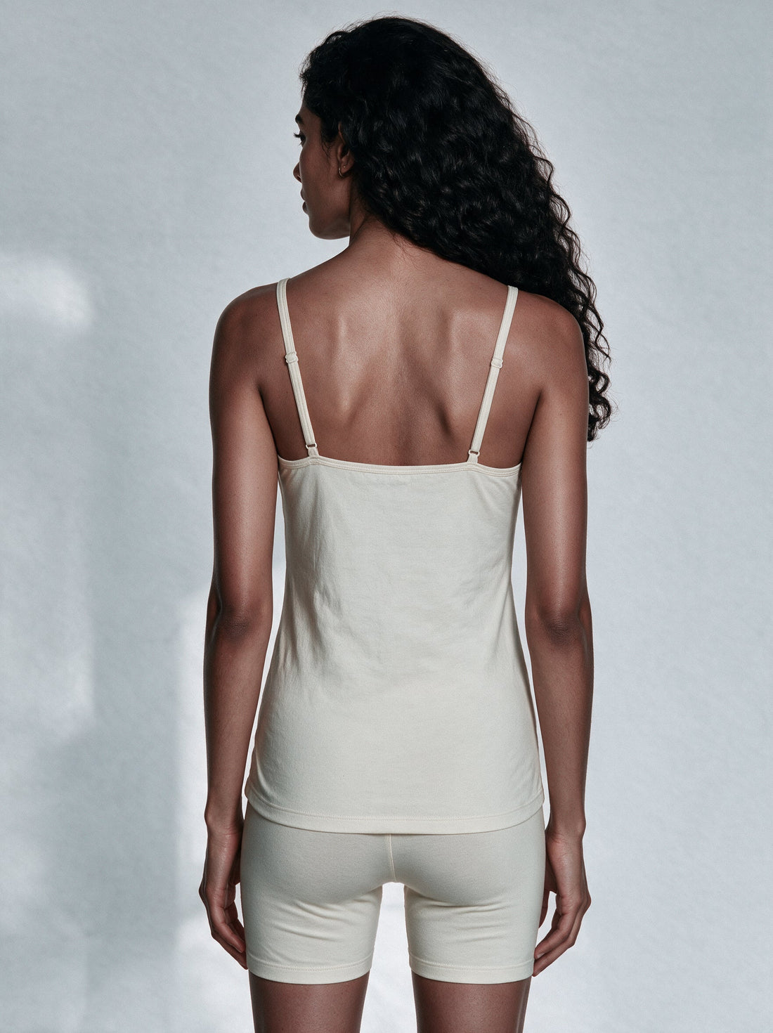 Organic cotton camisole and a satin slip laid side by side for comparison