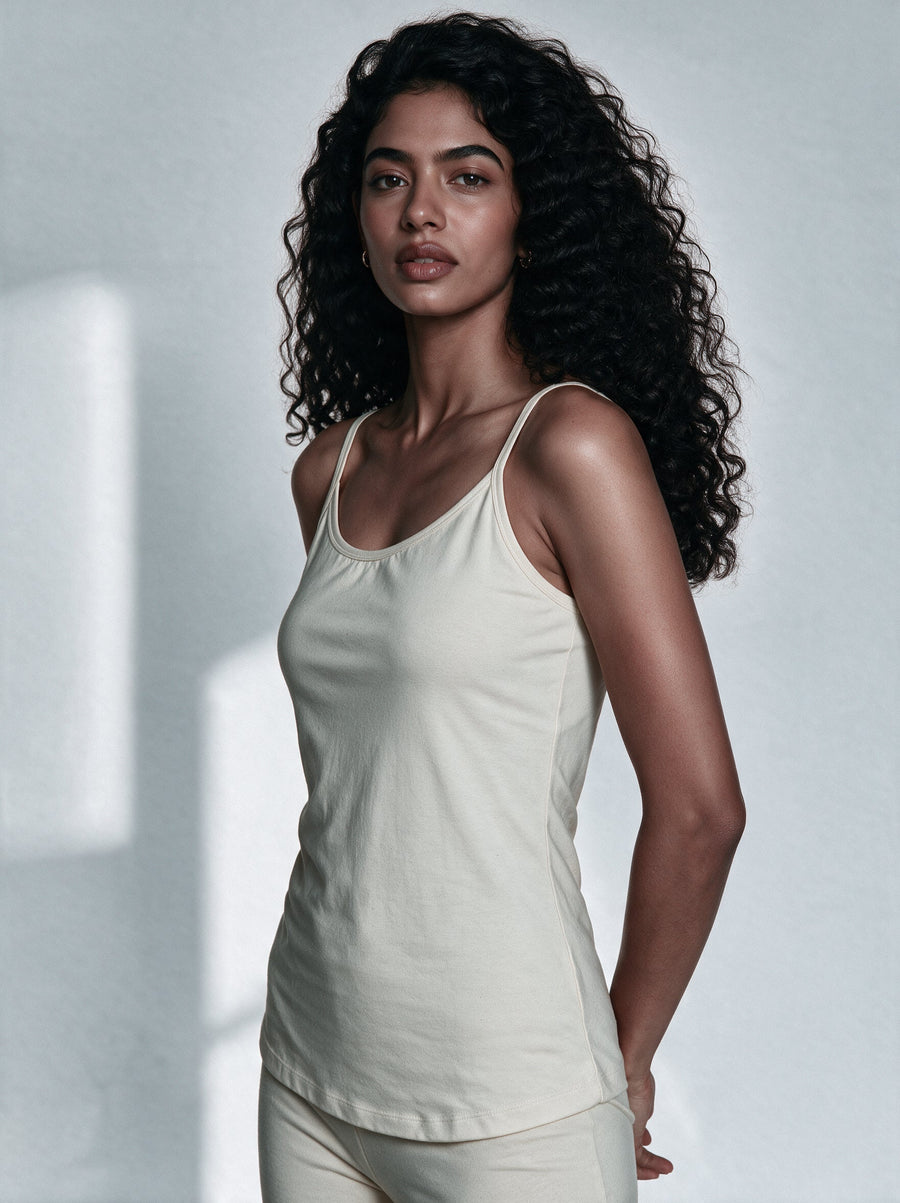 Cotton camisole and cotton tank top laid side by side showing strap and fabric difference