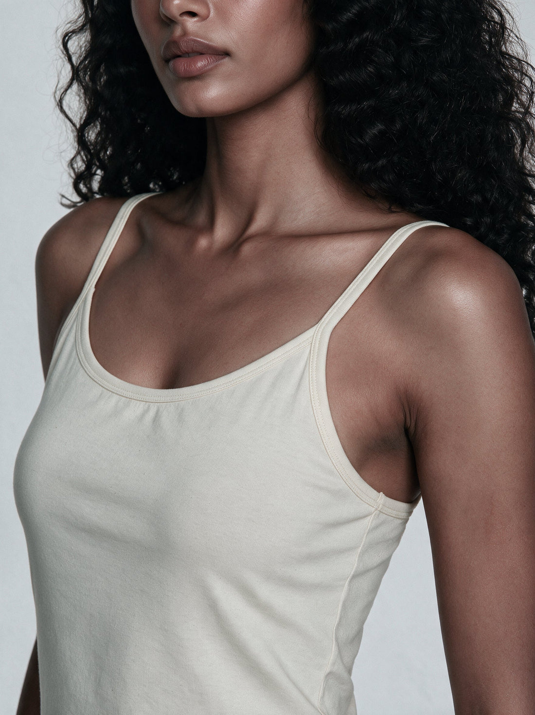 Organic cotton camisoles in natural undyed cotton laid flat on a soft background